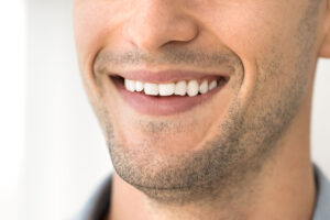 a man smiling with a perfect smile